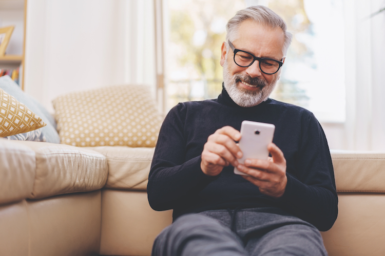 Elderly man using smart phone